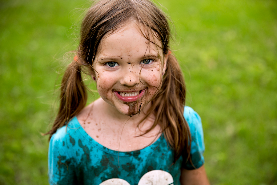 little girl with a muddy face