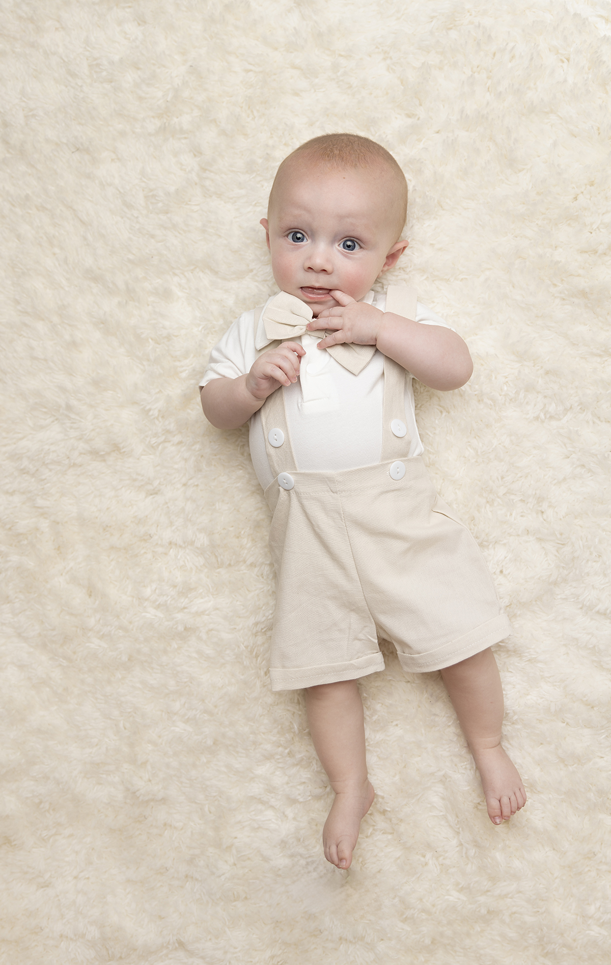 6 month photo session client closet shorts suspenders bowtie neutral colors