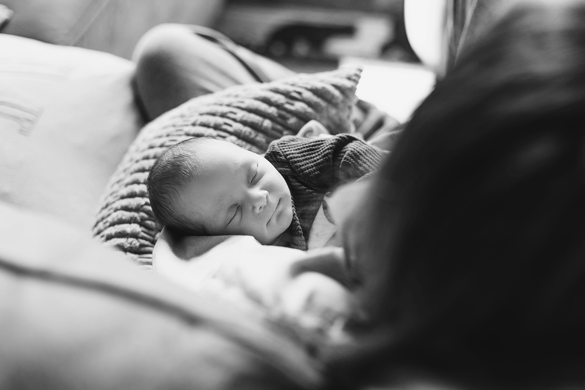 newborn snuggled in mom's arms