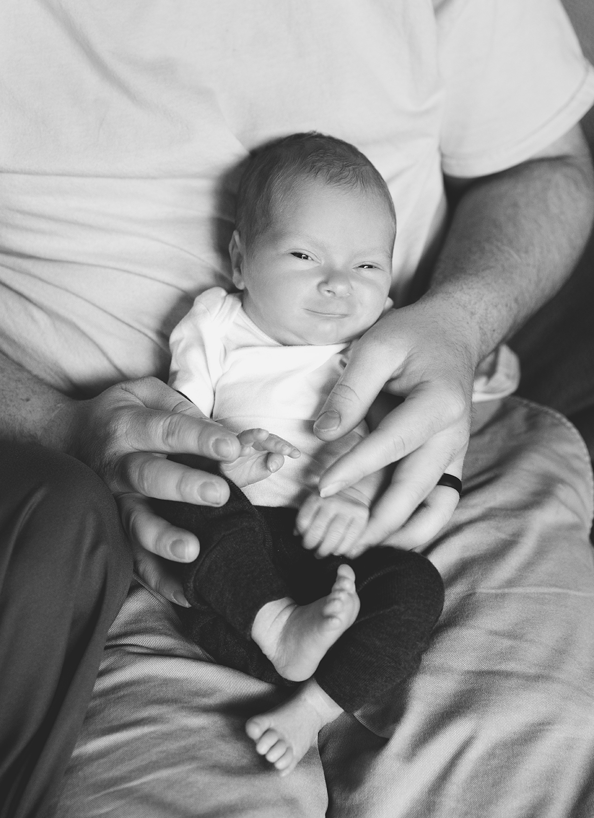 newborn in dads arms