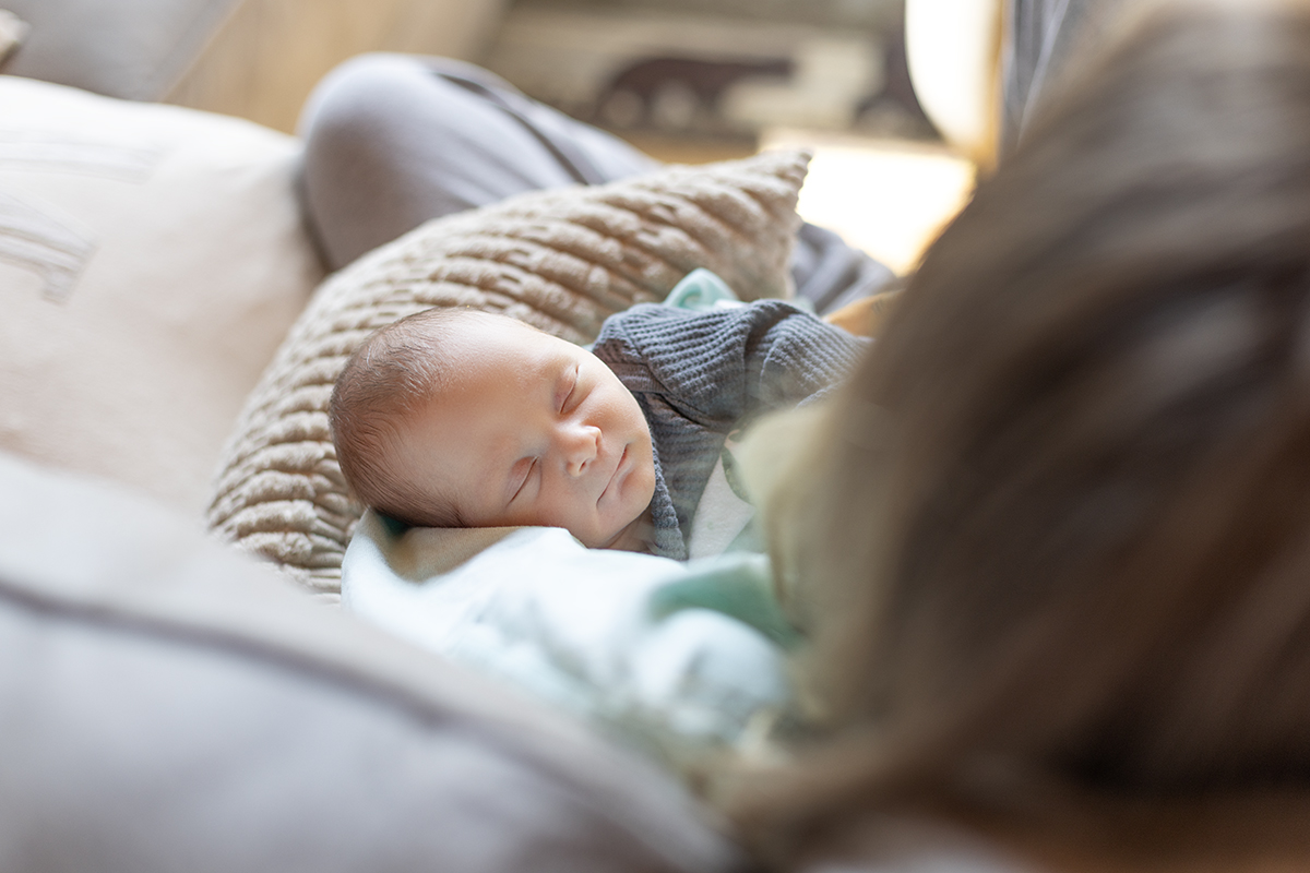 newborn snuggled in mom's arms