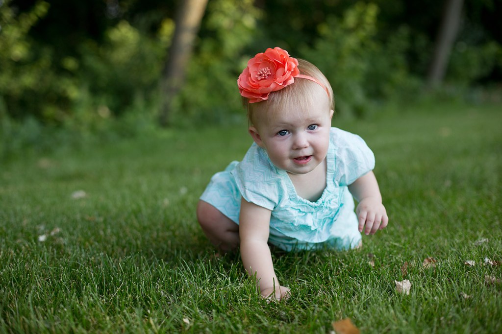 Baby crawling through grass