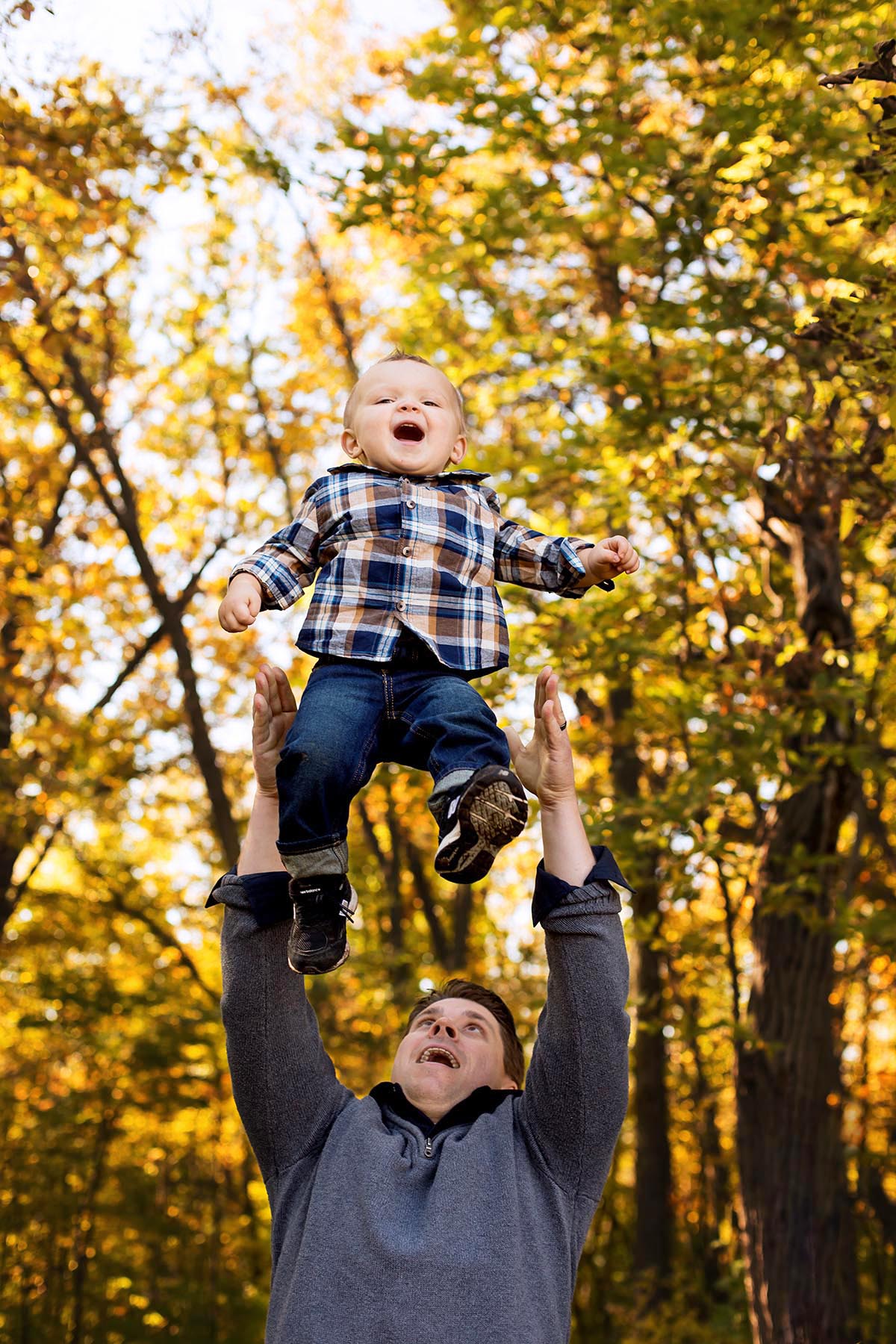Dad throwing son in the air