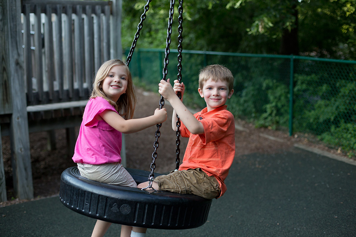 Kids playing on a tire swing