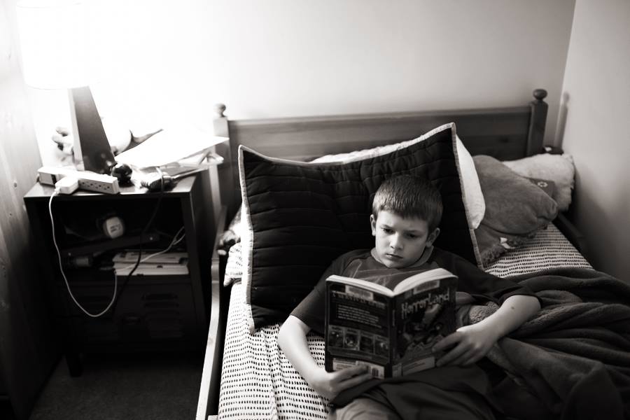 Tween reading a book in bed