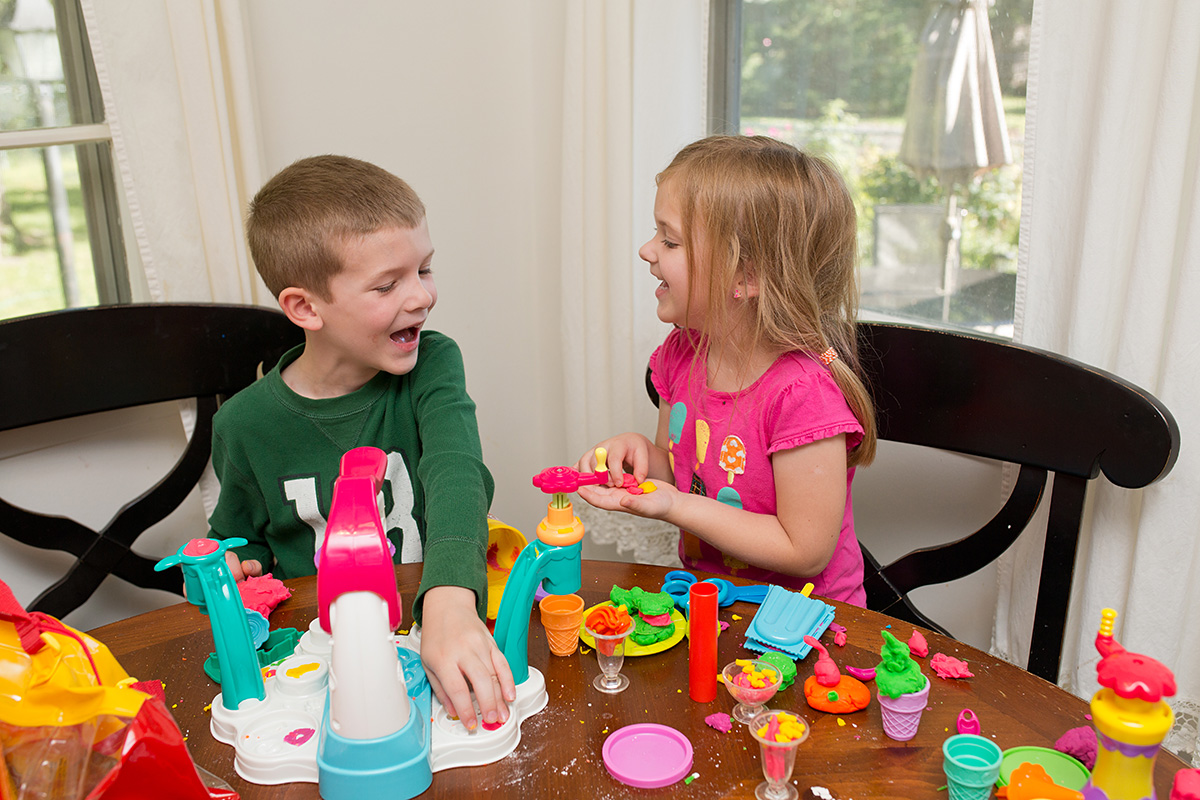 kids giggling with playdoh