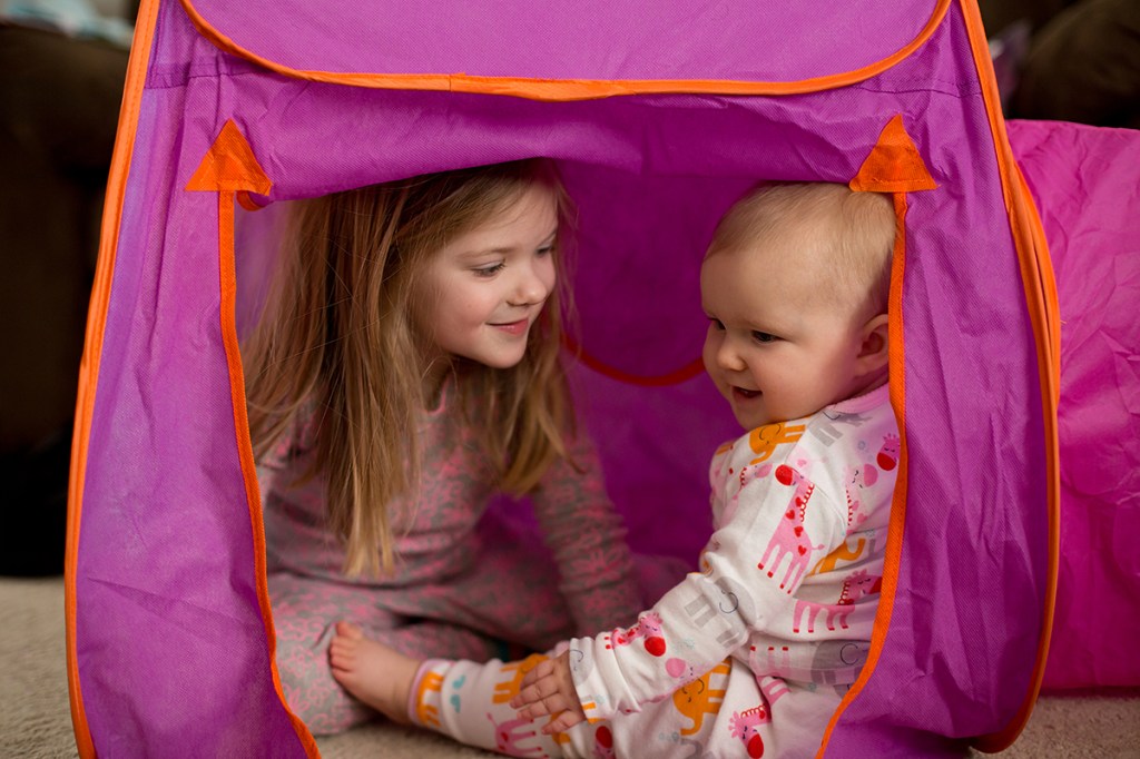 Sisters playing in a fort